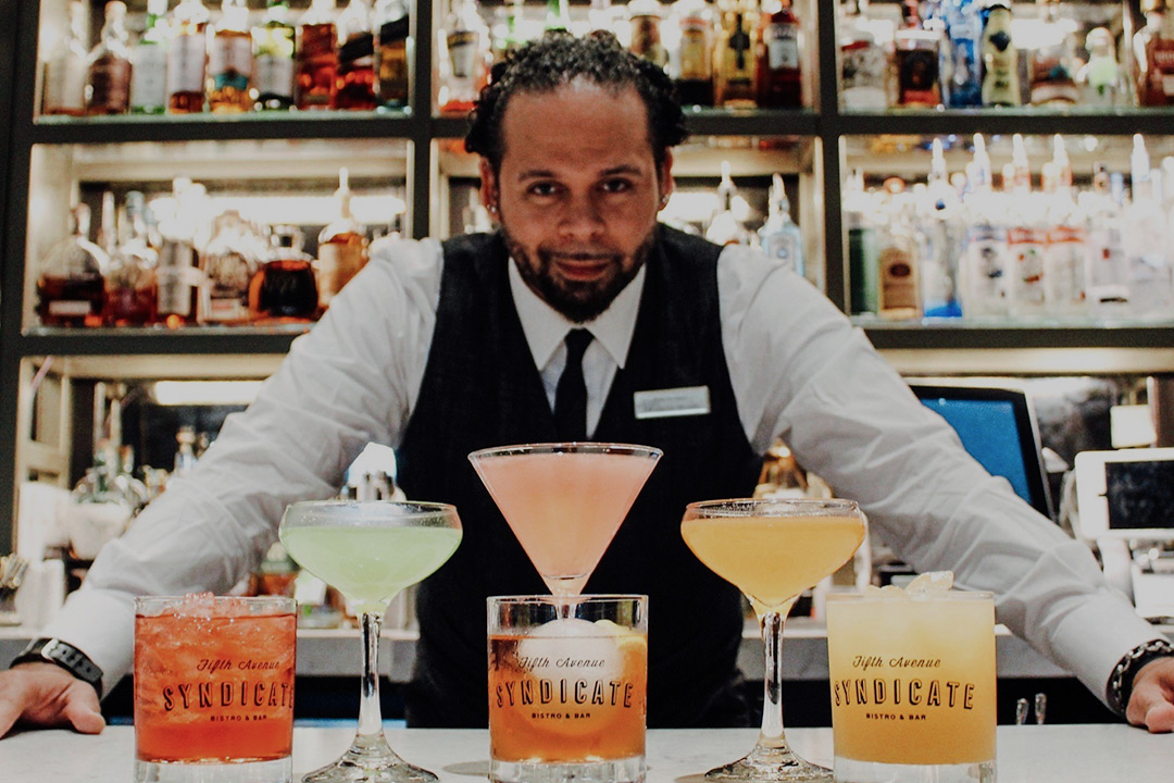 bartender in front of craft cocktails